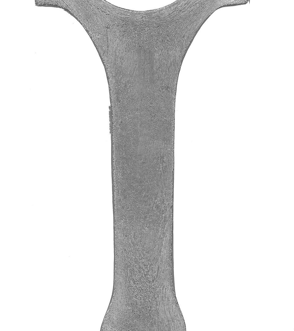 Etched cross-section of a forged component showing continuous directional grain flow around its contour