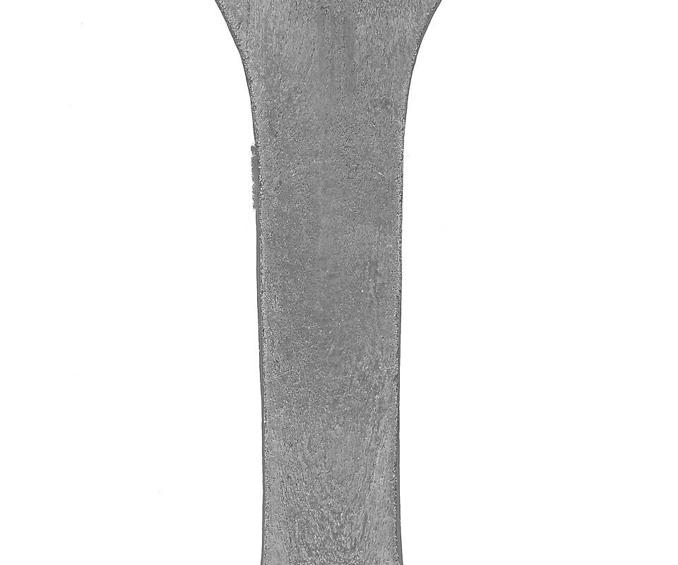 Etched cross-section of a forged component showing continuous directional grain flow around its contour
